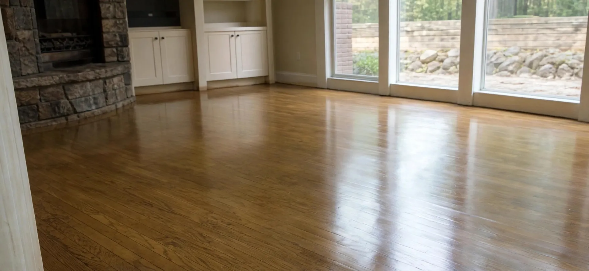 Same living room after water extraction and drying, with dry restored hardwood floors — visual representation